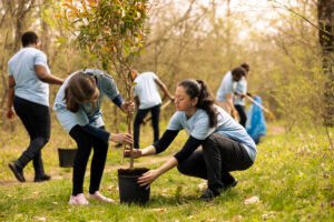 mother and daughter preparing to plant a tree in the woods